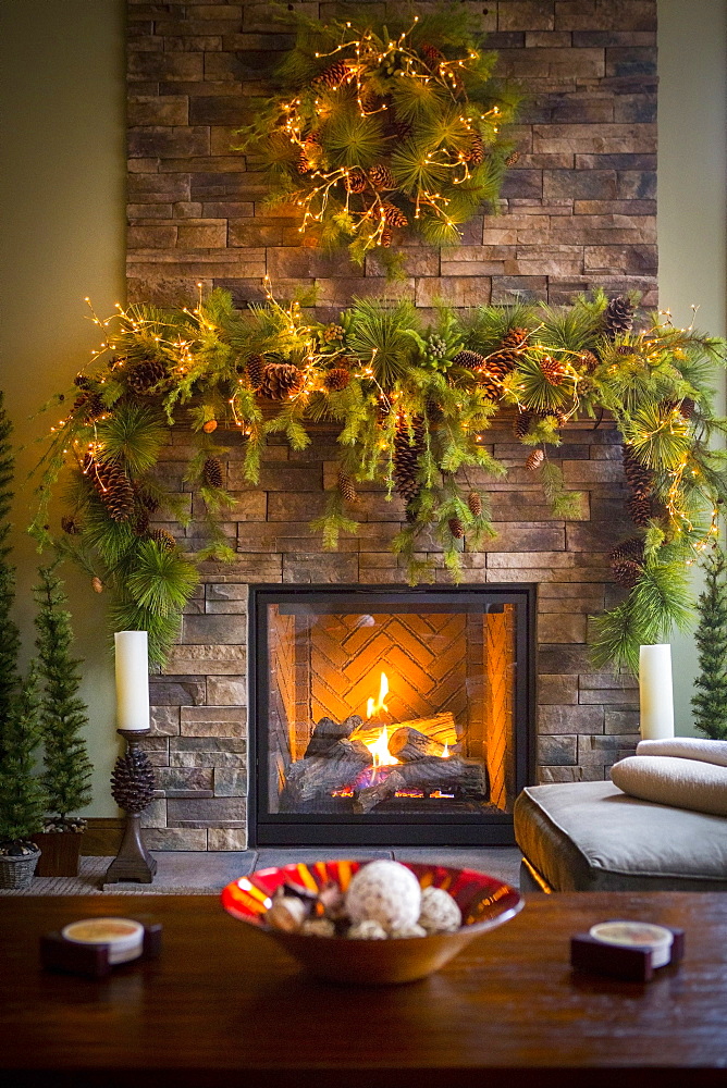 Christmas wreaths over fireplace in living room