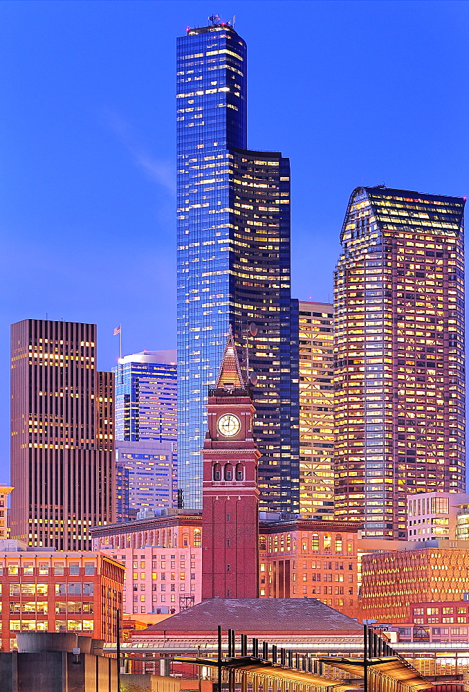 Clock tower and illuminated high rise buildings in Seattle city skyline, Washington, United States