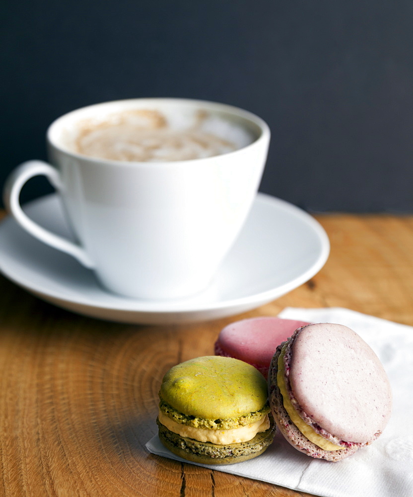 Close up of macaroon cookies and cup of coffee, Seattle, Washington, USA