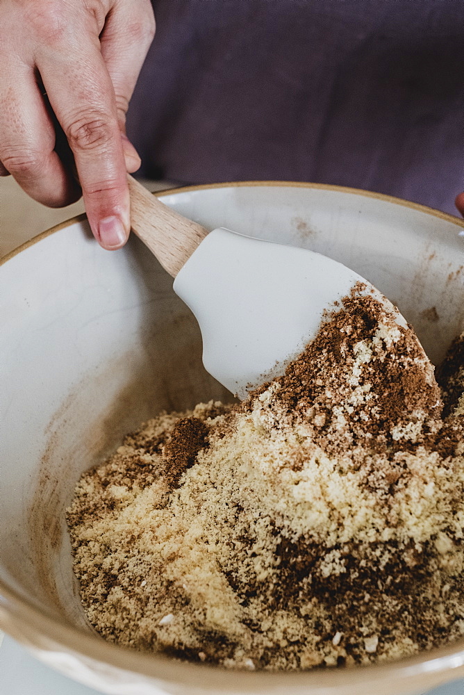 High angle close up of person mixing baking ingredients using spatula, England