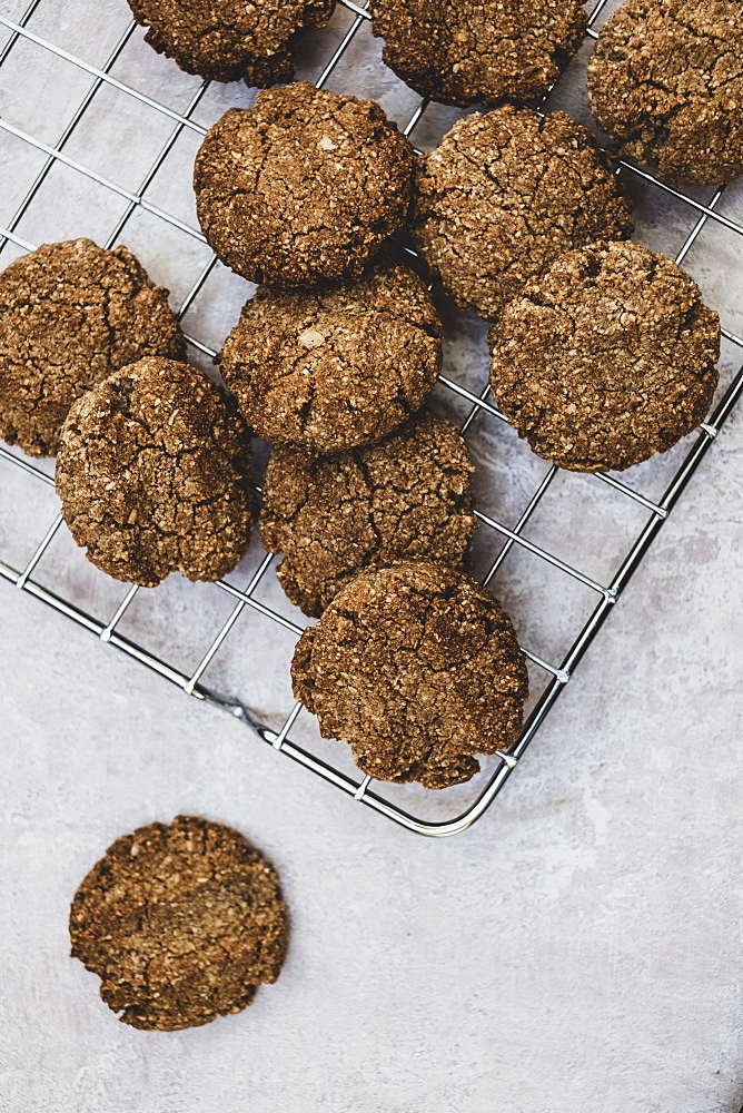 High angle close up of freshly baked chocolate cookies on a baking tray, England