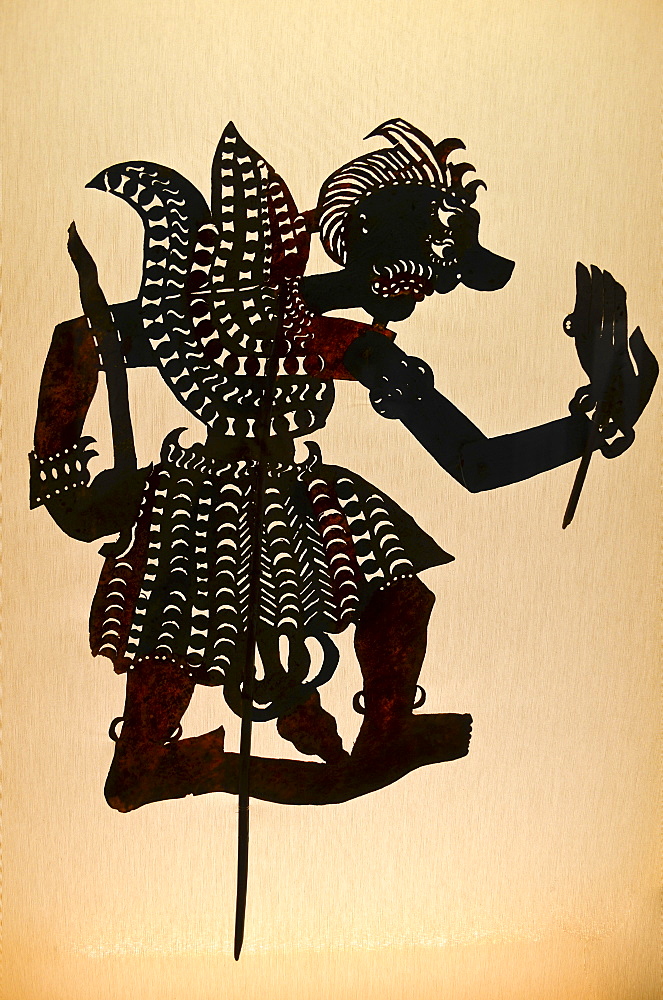 Silhouette of a shadow puppet, a jointed shape of a warrior, a wayang puppet from Indonesian culture, Indonesia