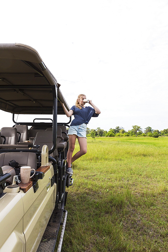 Thirteen year old girl on safari vehicle, Botswana
