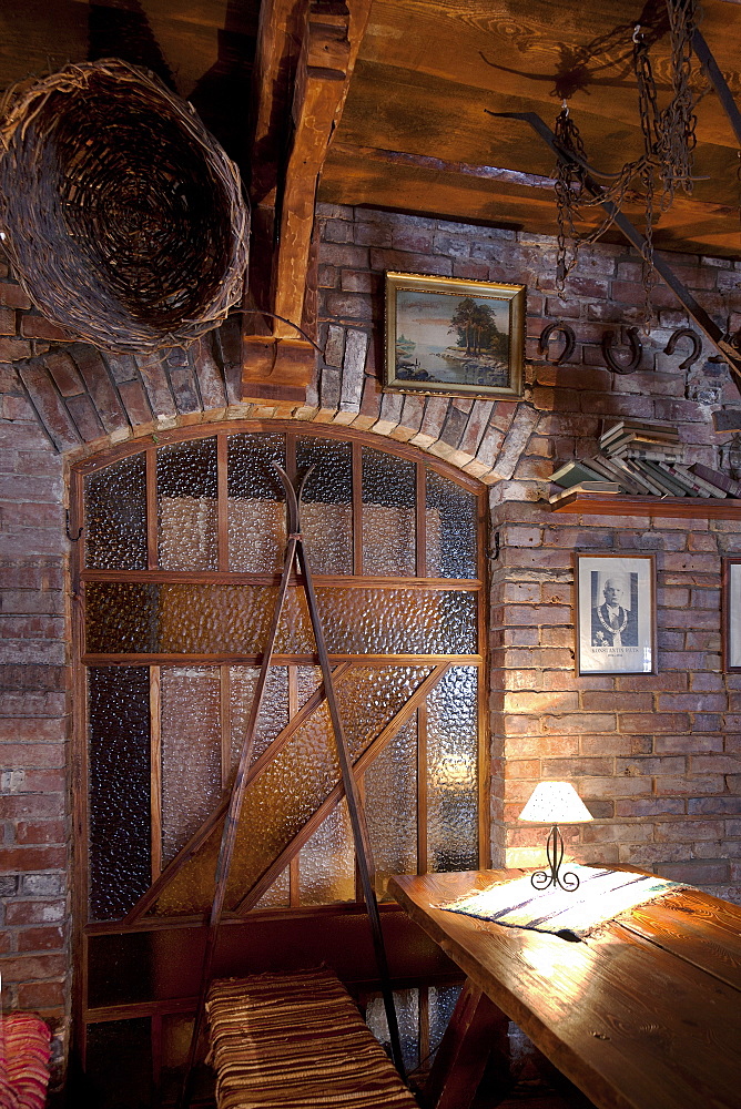 A hotel with old fashioned retro styled rooms, and rustic objects, staine glass, exposed brick and old photographs, Estonia