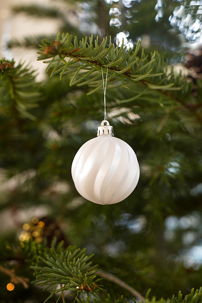 Close up of white bauble on Christmas Tree