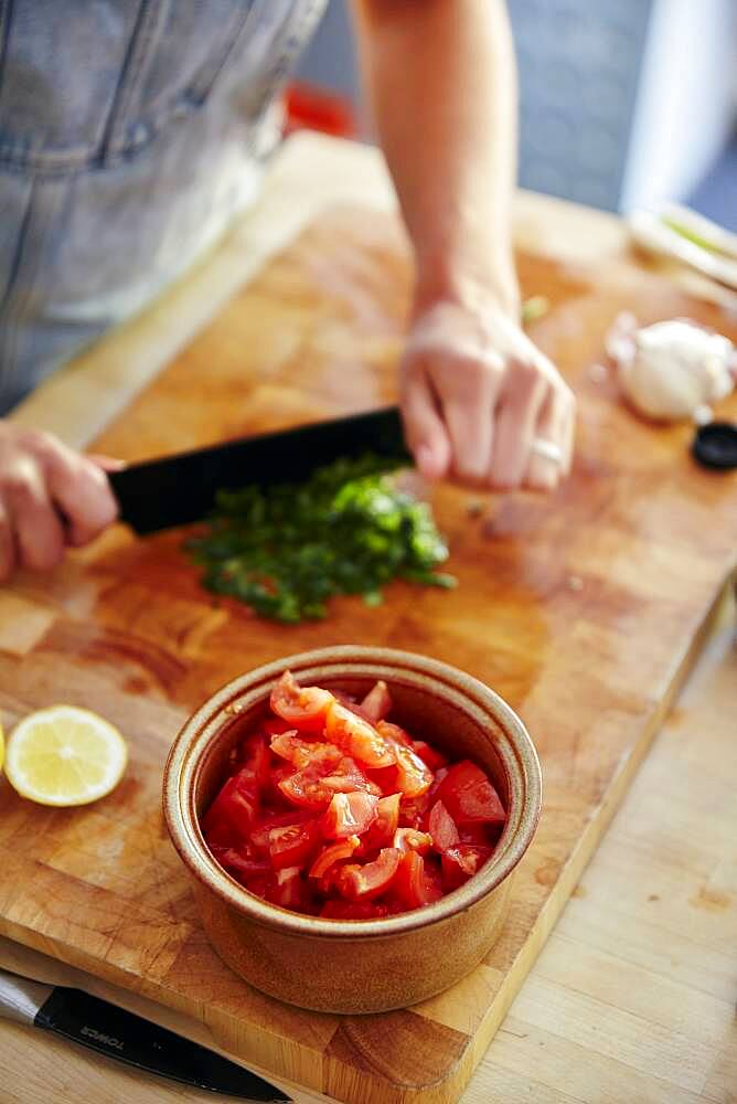 Chopping basil for tomato salad