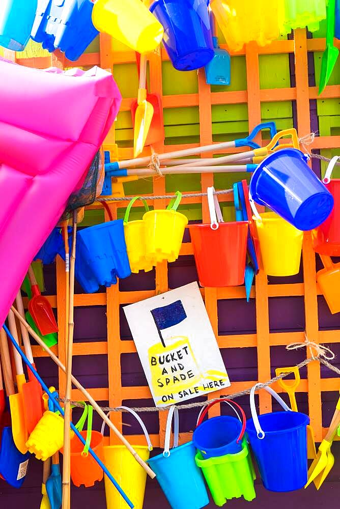 Bucket and spades and other beach items for sale, holiday resort, England