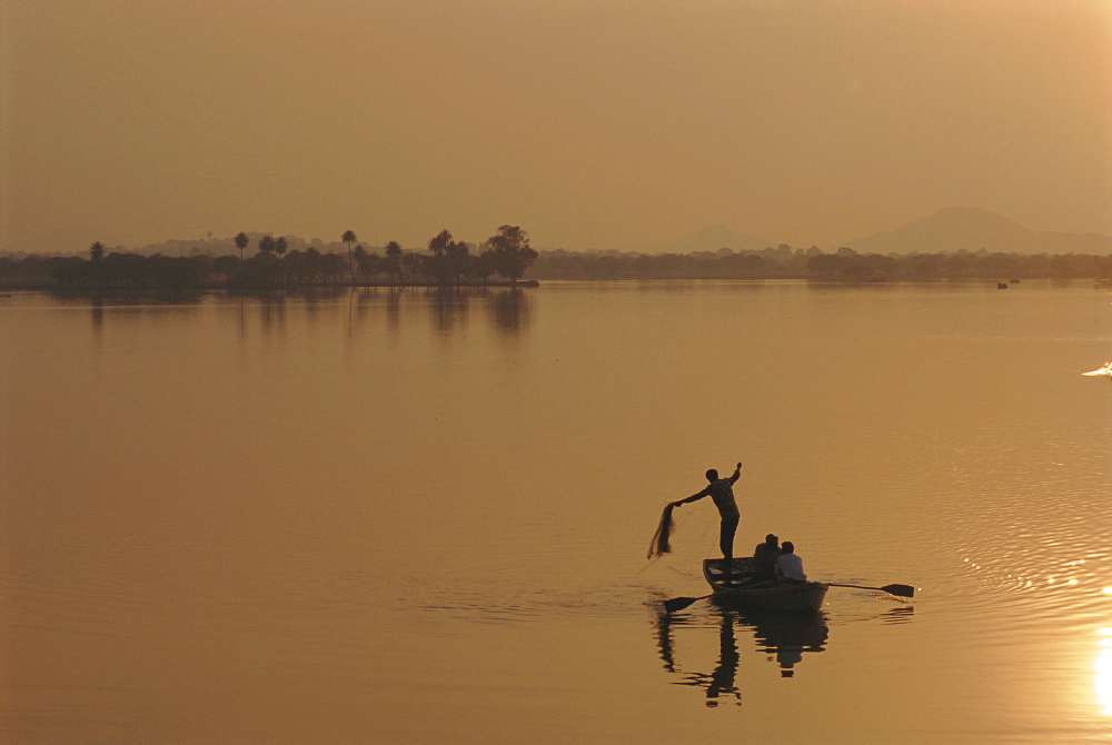 Sunset over lake created by dam, Deogarh, Rajasthan, India