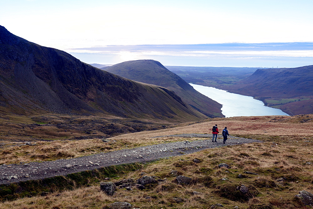 Two men descend from Scafell Pike towards Wast Water, Lake District, Cumbria, England, United Kingdom, Europe