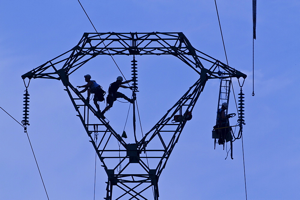 Workers on pylon, Brittany, France, Europe 