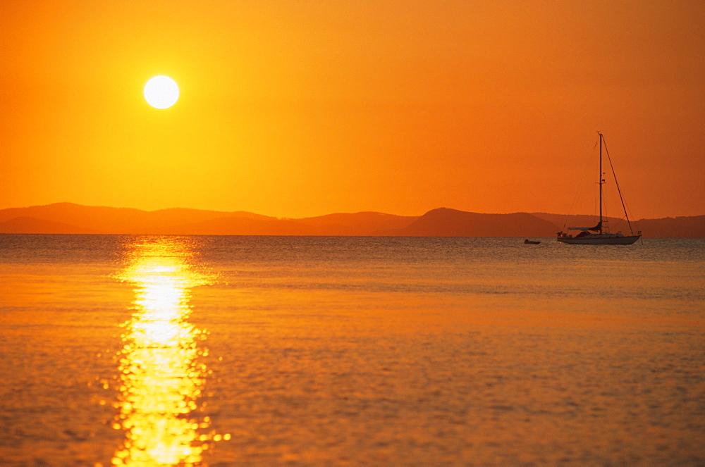 View to mainland from Monkey Beach at sunset, Great Keppel Island, Queensland, Australia