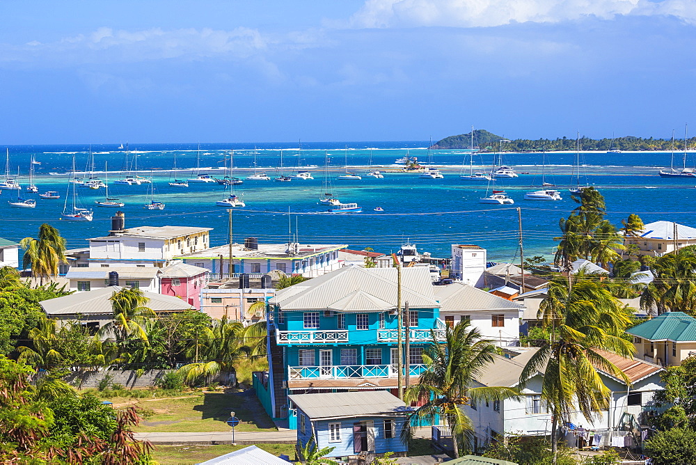 View of Clifton and Clifton harbour, Union Island, with Palm Island in the distance, The Grenadines, St. Vincent and The Grenadines, West Indies, Caribbean, Central America