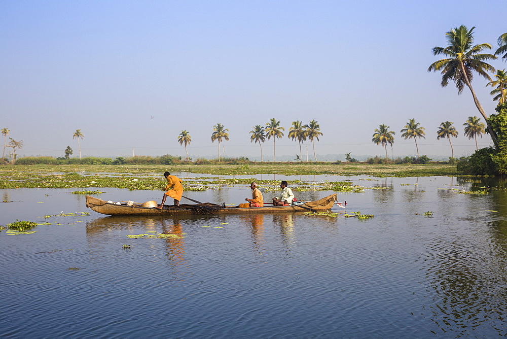 Men fishing from dugout canoe, Backwaters, Alappuzha (Alleppey), Kerala, India, Asia