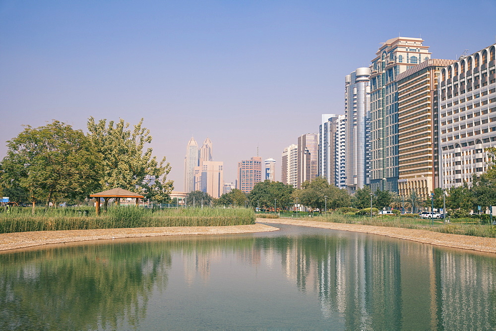 City Center buildings reflecting in Corniche Lake, Abu Dhabi, United Arab Emirates, Middle East