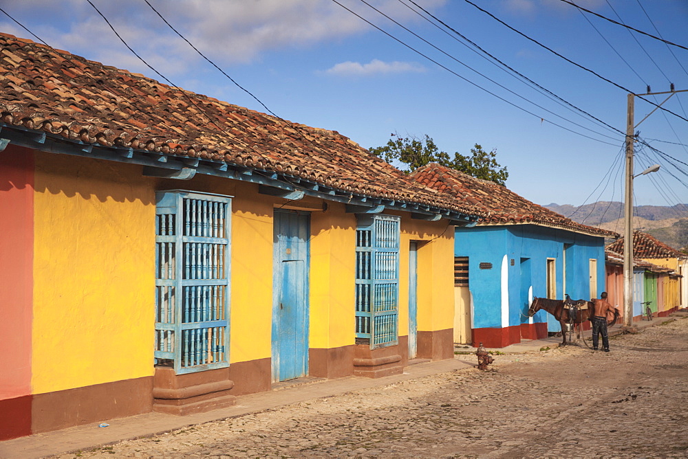 Horse outside colourful houses in historical center, Trinidad, Sancti Spiritus Province, Cuba, West Indies, Caribbean, Central America