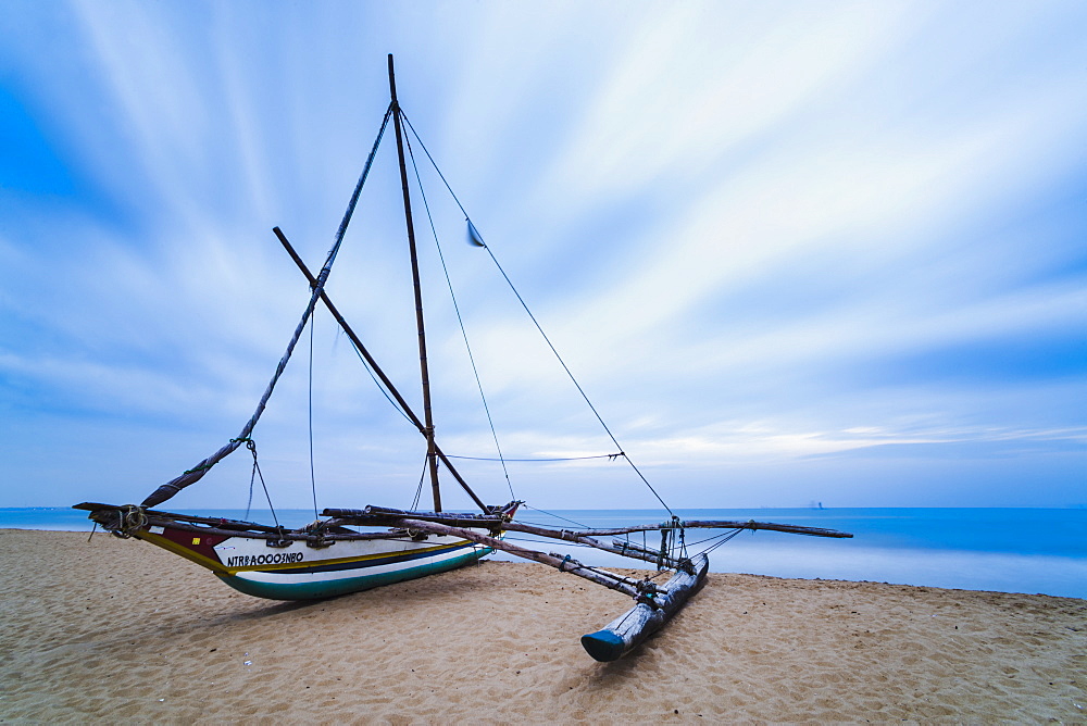 Outrigger fishing boat on Negombo Beach at sunrise, Sri Lanka, Asia