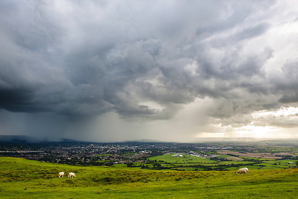 Looking out from Cleve Hill as a storm crosses the Severn Vale, Cheltenham, Gloucestershire, England, United Kingdom, Europe 