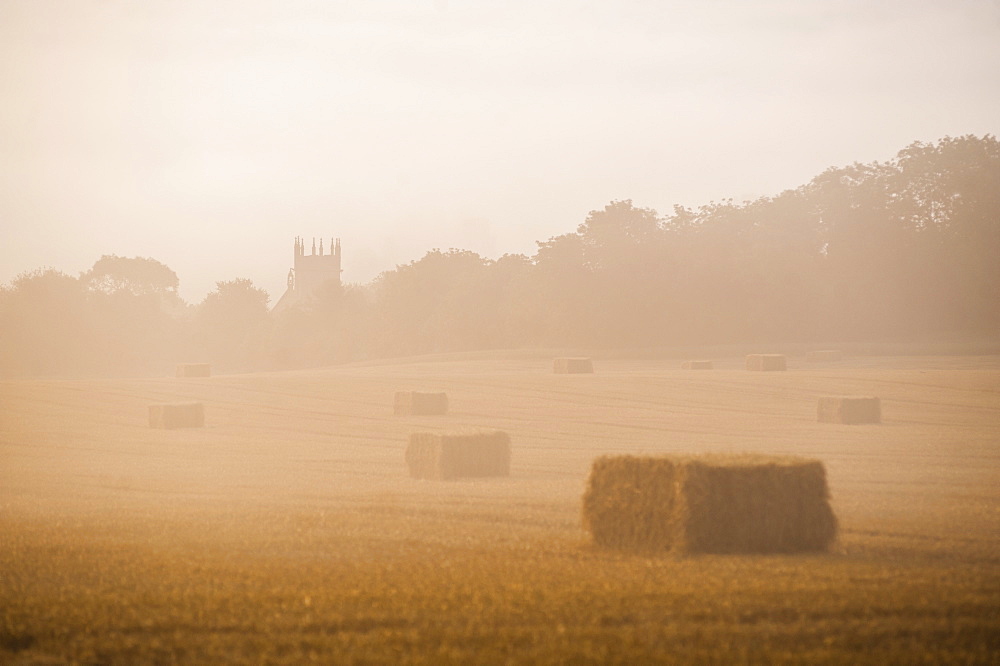 Misty sunrise at St. James Church at Longborough, a village in The Cotswolds, Gloucestershire, England, United Kingdom, Europe  