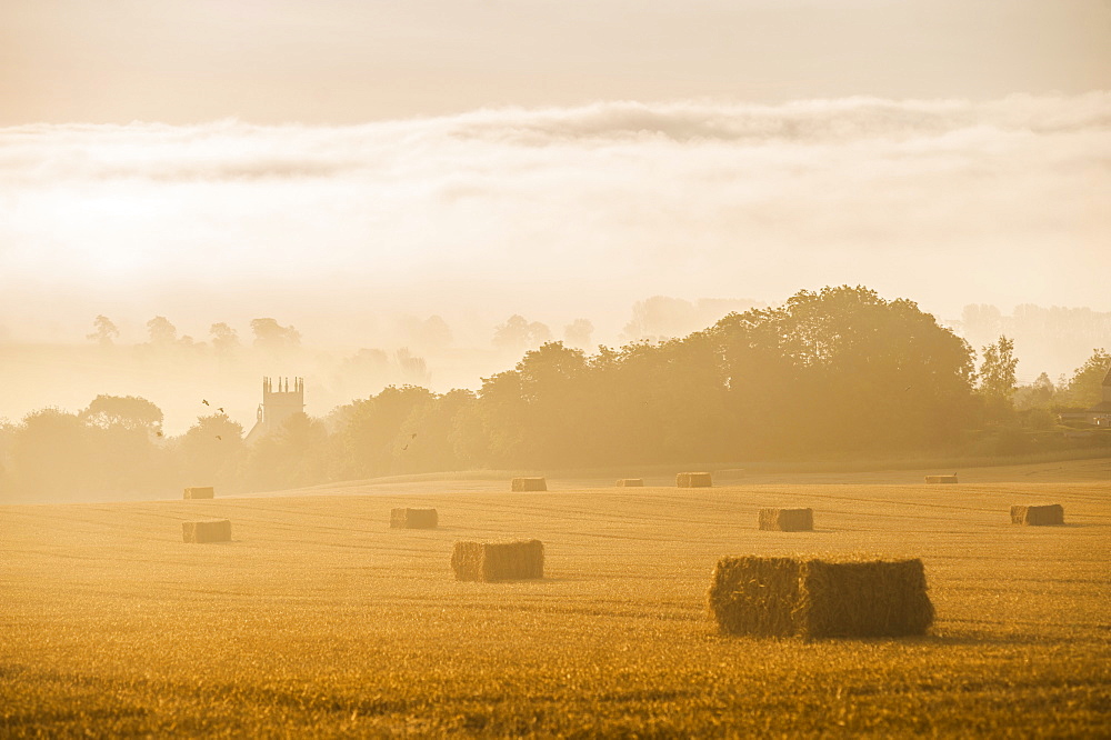 Misty sunrise at St. James Church at Longborough, a village in The Cotswolds, Gloucestershire, England, United Kingdom, Europe 