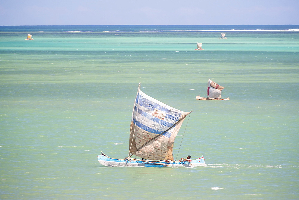 Fisherman fishing from a Pirogue, a traditional Madagascar sailing boat, Ifaty, Madagascar, Africa