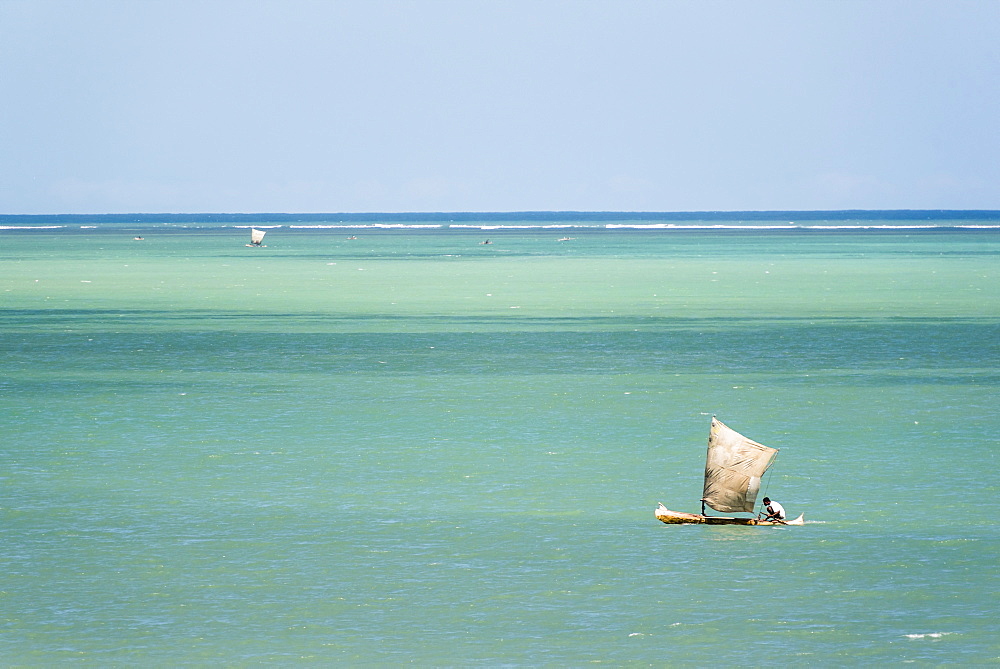 Fisherman fishing from a Pirogue, a traditional Madagascar sailing boat, Ifaty, Madagascar, Africa