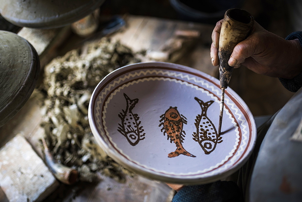 Woman decorating Horezu ceramics, a unique type of Romanian pottery, UNESCO Cultural Heritage List, Wallachia, Romania, Europe