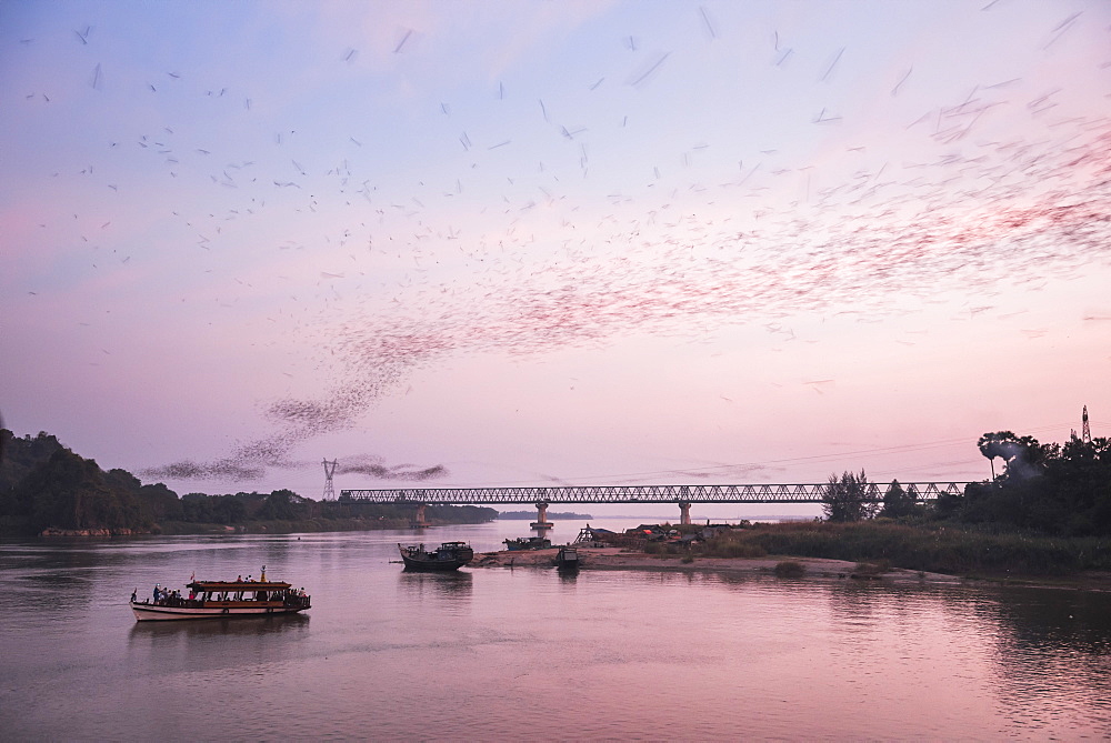 Bats swarming out of the Bat Cave at sunset, Hpa An, Kayin State (Karen State), Myanmar (Burma), Asia