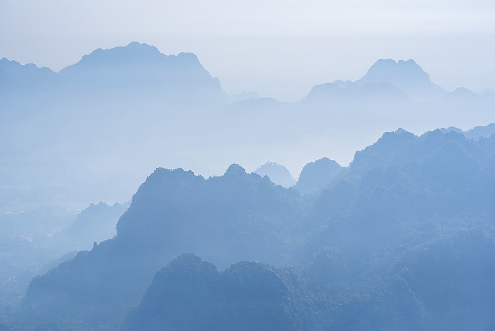 Misty limestone karst mountain landscape at sunrise, seen from Mount Zwegabin, Hpa An, Kayin State (Karen State), Myanmar (Burma), Asia