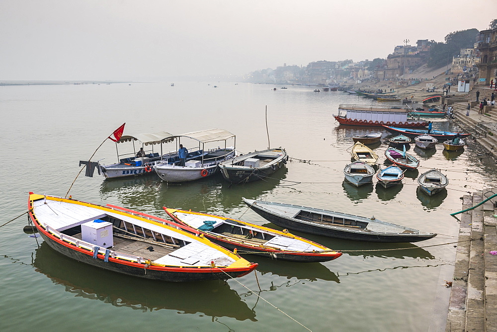 Boats in the mist at dawn on the River Ganges, Varanasi, Uttar Pradesh, India, Asia