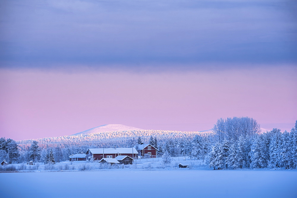 Sunrise on frozen Torassieppi Lake, Lapland, Finland, Europe