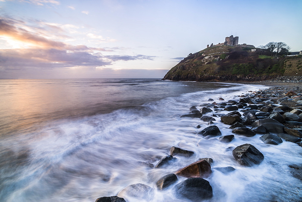 Criccieth Castle, above Criccieth Beach at sunrise, Gwynedd, North Wales, United Kingdom, Europe