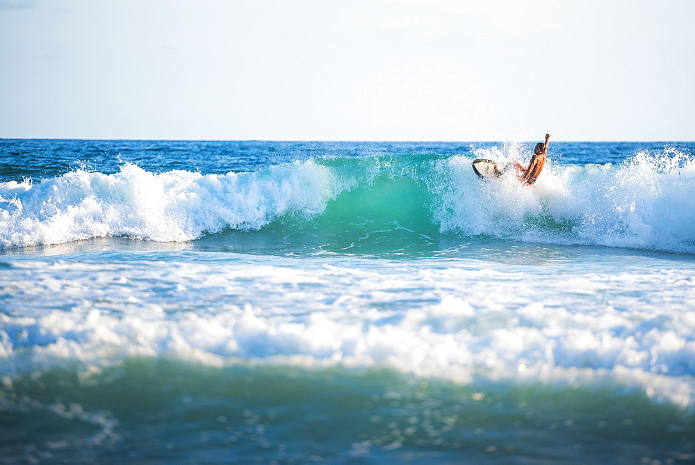 Surfers surfing on a beach, Nosara, Guanacaste Province, Pacific Coast, Costa Rica, Central America