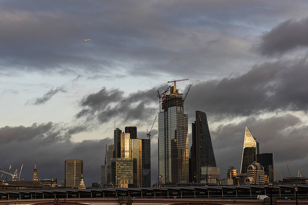 Aeroplane flying over The City of London, London, England, United Kingdom, Europe