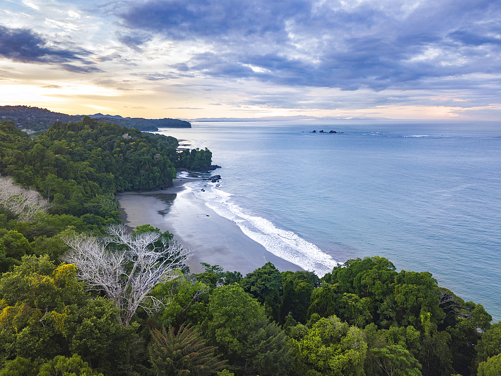 Drone view of Arco Beach and rainforest at sunrise, Uvita, Puntarenas Province, Pacific Coast of Costa Rica, Central America