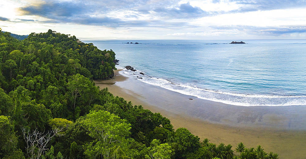 Drone view of Arco Beach and rainforest at sunrise, Uvita, Puntarenas Province, Pacific Coast of Costa Rica, Central America