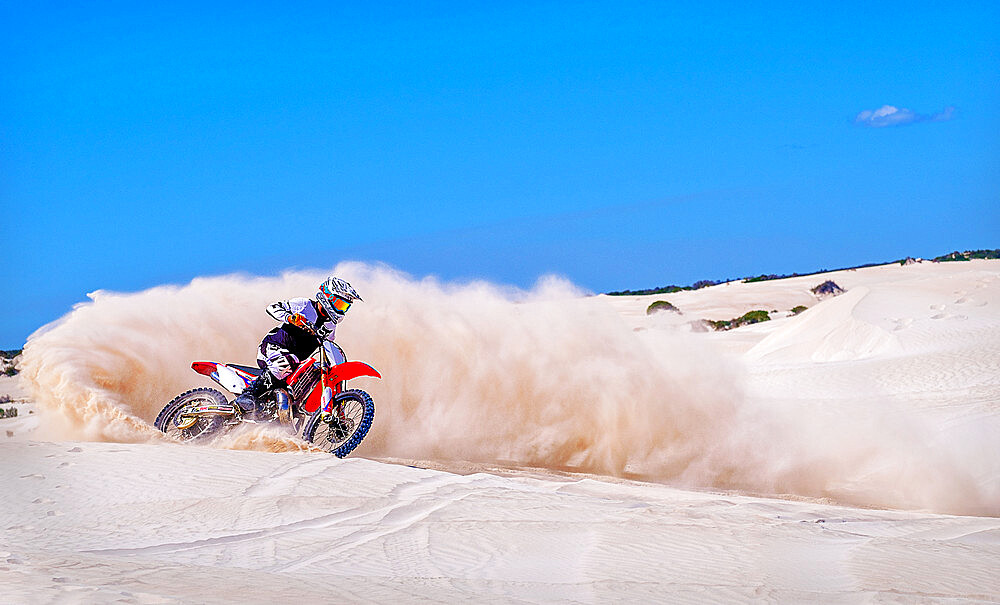 Trial bike rider kicking up sand at the sand dunes of Lancelin, Western Australia, Australia, Pacific