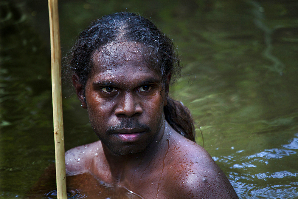 Aboriginal Yolngu man in billabong, Nyinyikay Homeland, East Arnhem Land, Northern Territory, Australia, Pacific