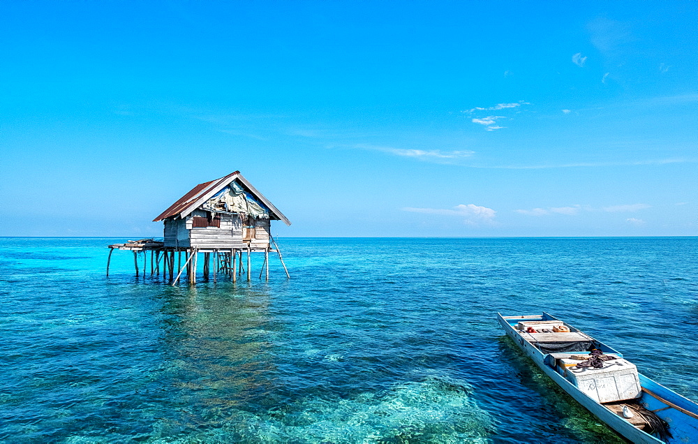 Huts built over the water by the Bajau Fishermen who live there three months of the year, Togian Islands, Indonesia, Southeast Asia, Asia