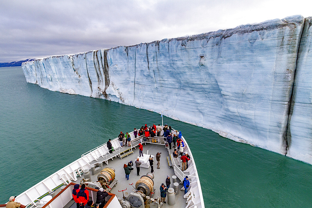 The Lindblad Expedition ship National Geographic Explorer near a glacier in the Svalbard Archipelago, Norway.