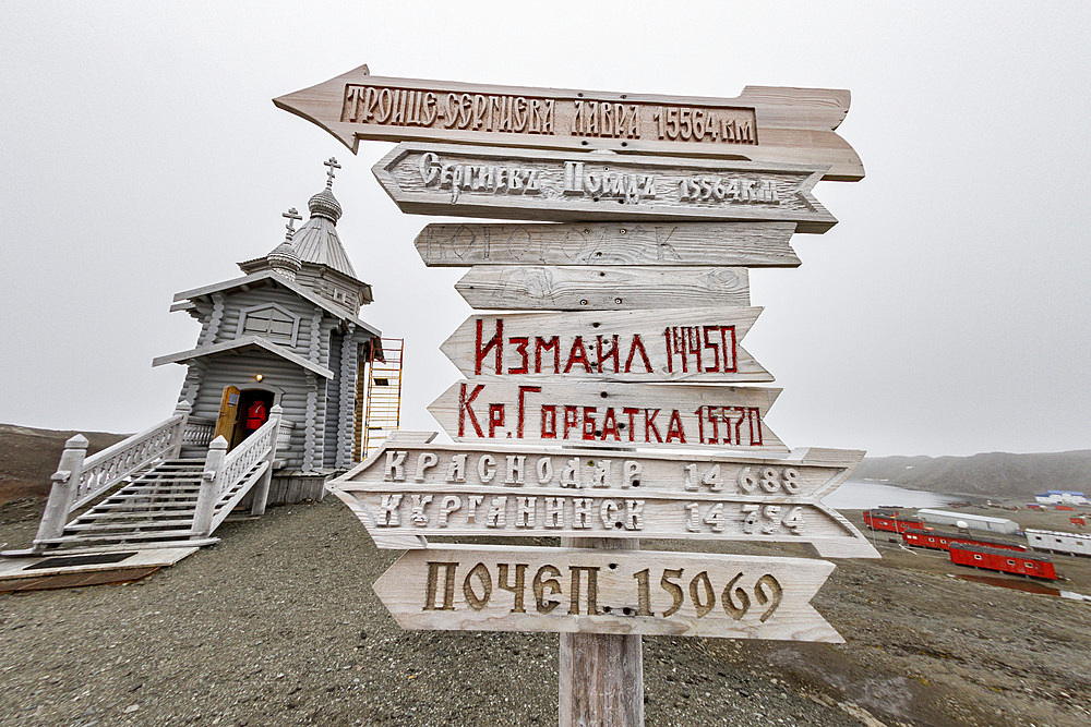 Views signpost and the Trinity Church at Belingshausen Russian Research Station, Antarctica, Southern Ocean, Polar Regions