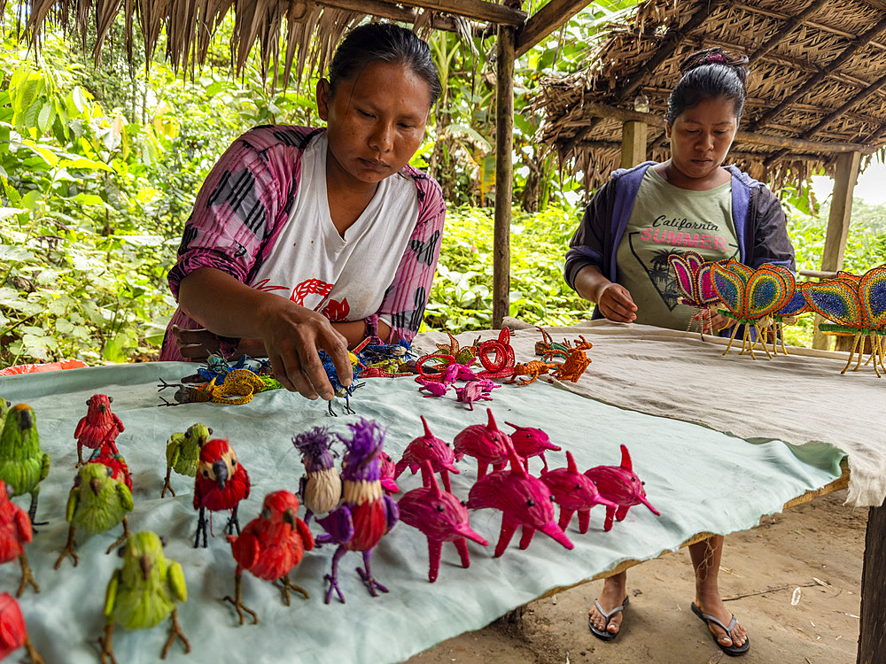 Women showing off their hand made wares in a small village deep within the Pacaya Samiria Preserve, Peru.