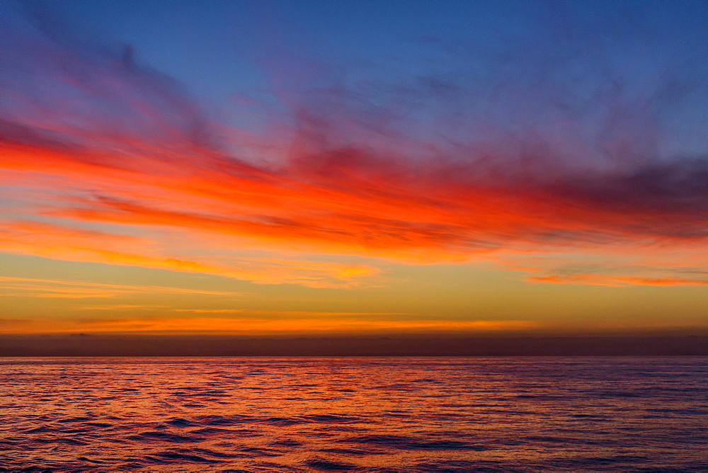 Sunrise off the coast of Akaroa, South Island, New Zealand, Pacific 