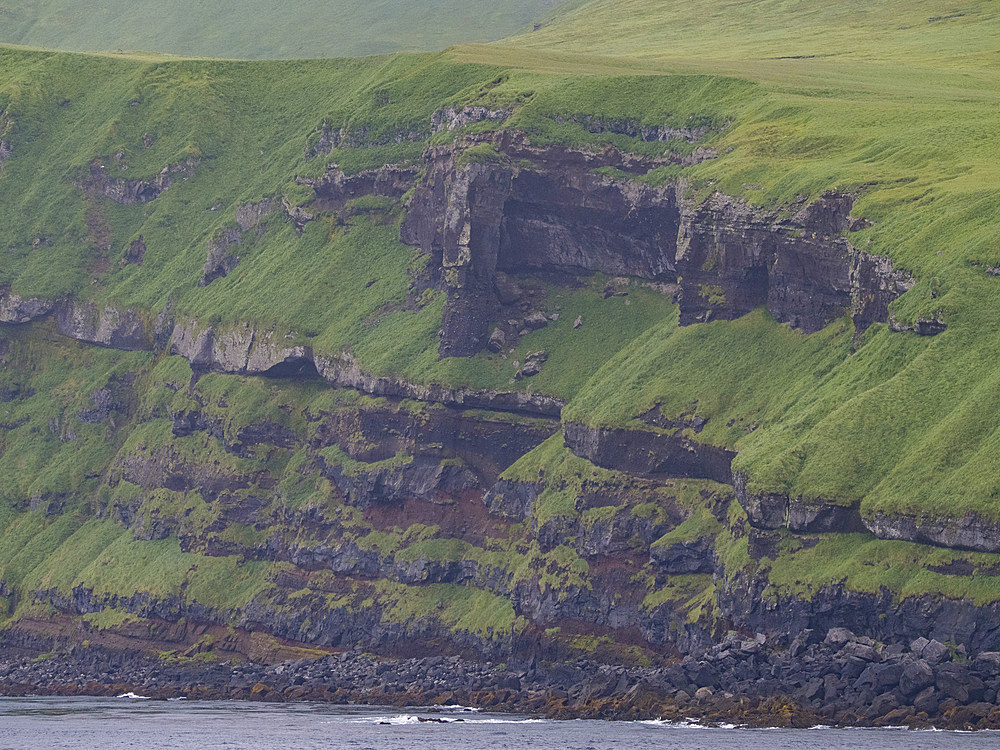 Rocky cliffs on Kagamil Island. Kagamil Island is one of the four mountains of the Aleutian Archipelago, Alaska.