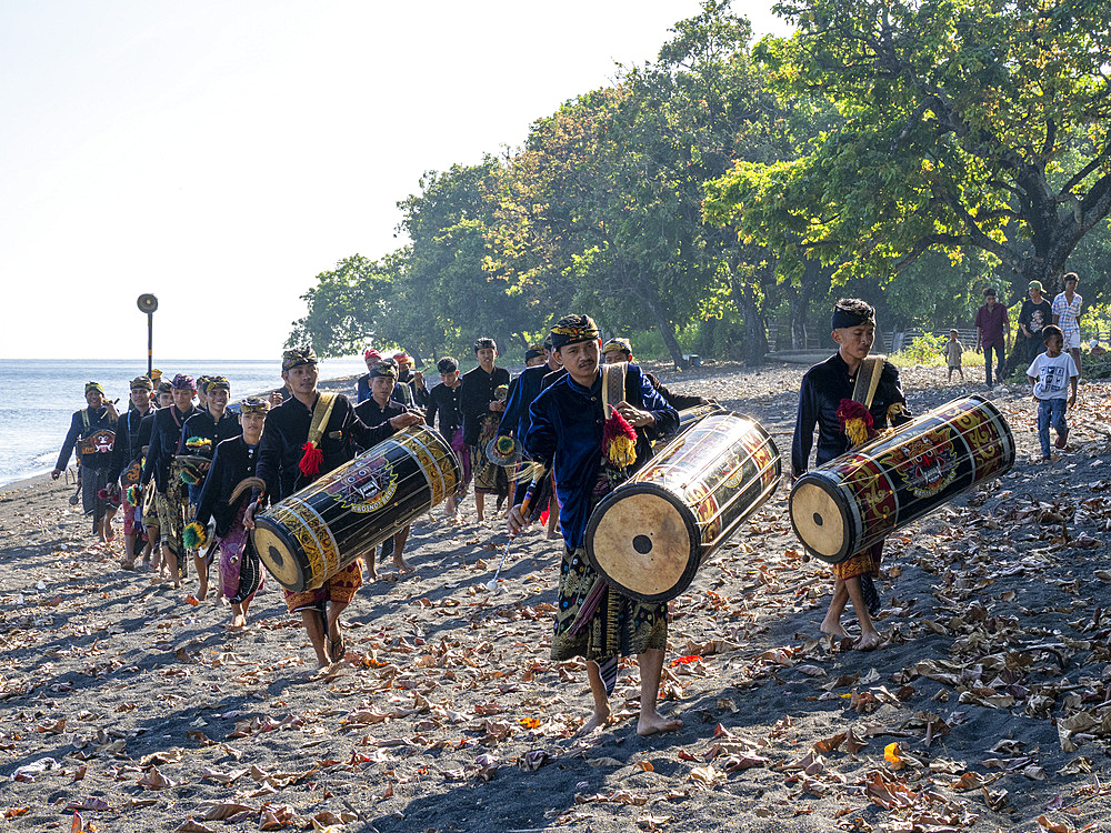Ceremonial drummers coming to perform with their ornately painted drums on Sumbawa Island, Indonesia.