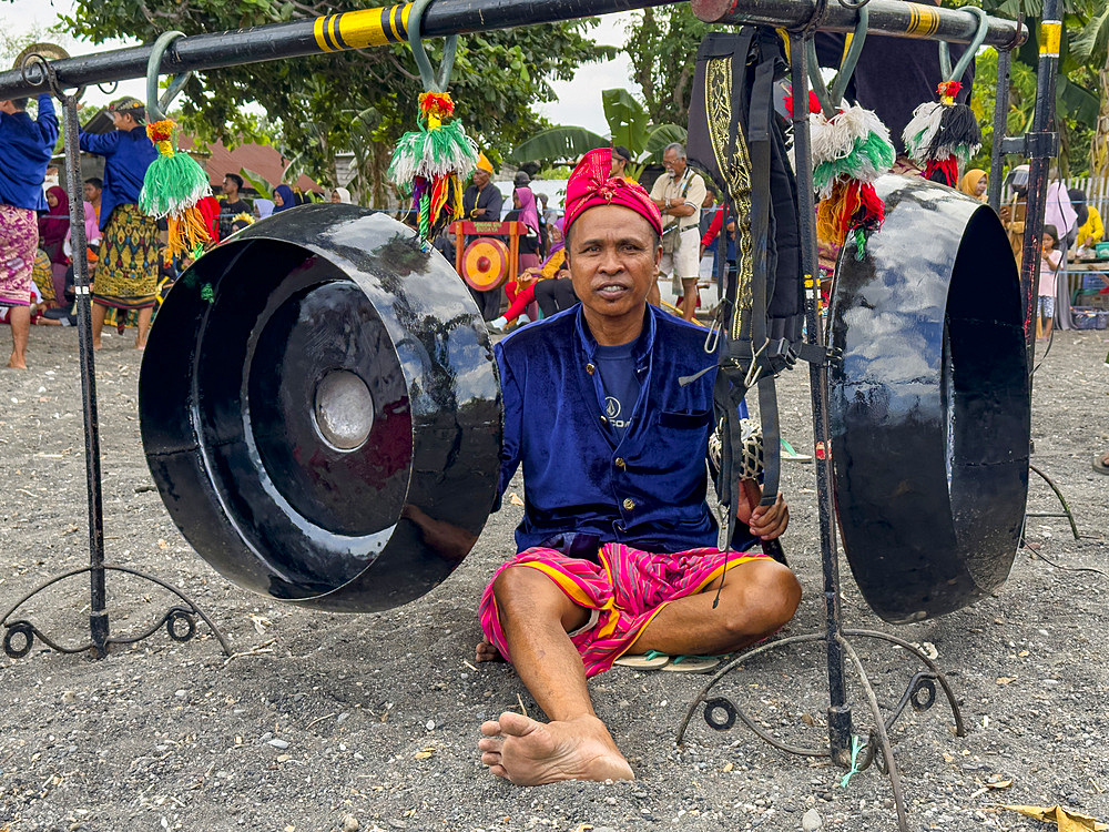 Ceremonial drummers coming to perform with their ornately painted drums on Sumbawa Island, Indonesia.