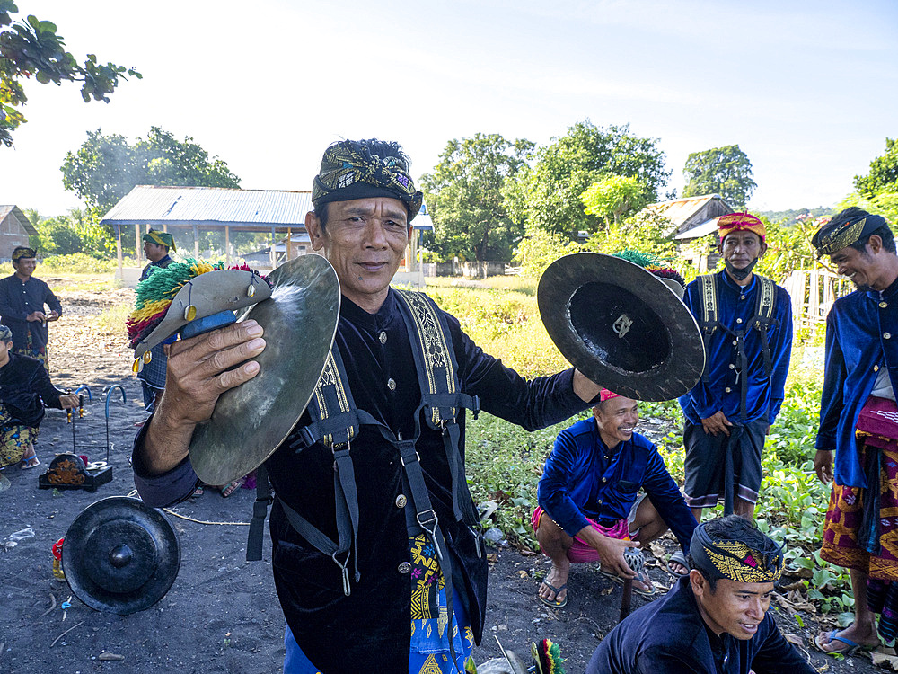 Ceremonial drummers coming to perform with their ornately painted drums on Sumbawa Island, Indonesia.