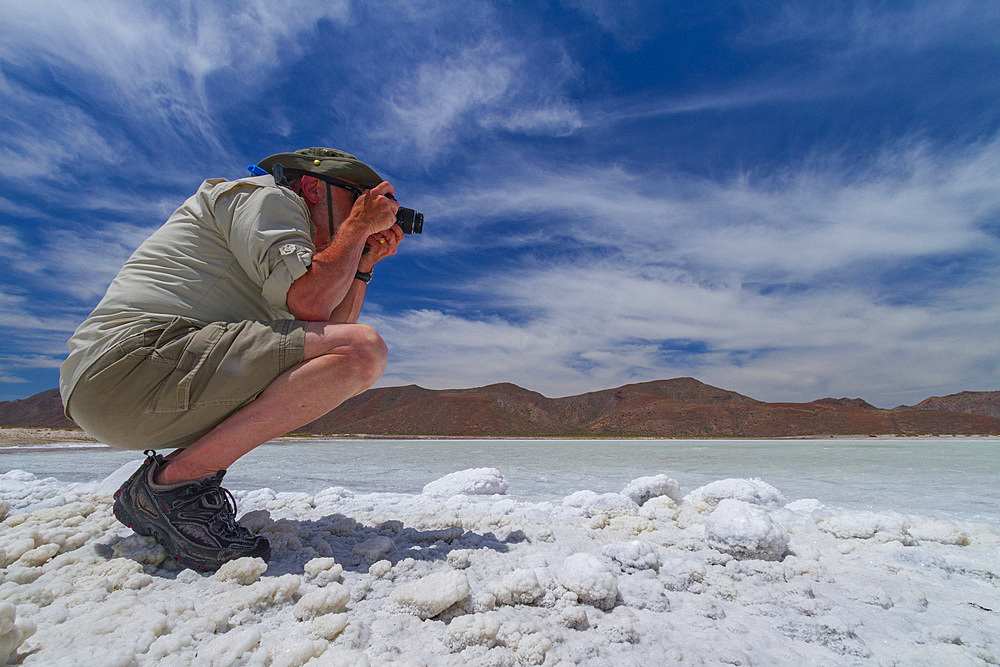 Tourists taking photos at the Salinas salt mine on Isla del Carmen in the Gulf of California, Baja California Sur, Mexico.
