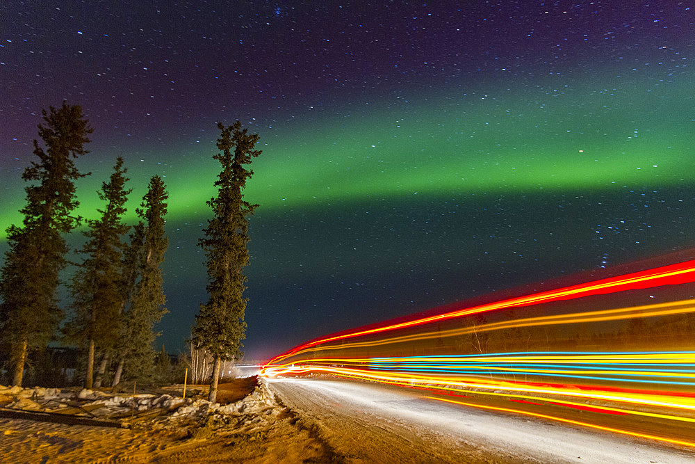 Long exposure of Jeep lights and Aurora Borealis, on the Great Slave Lake, Northwest Territories, Canada.