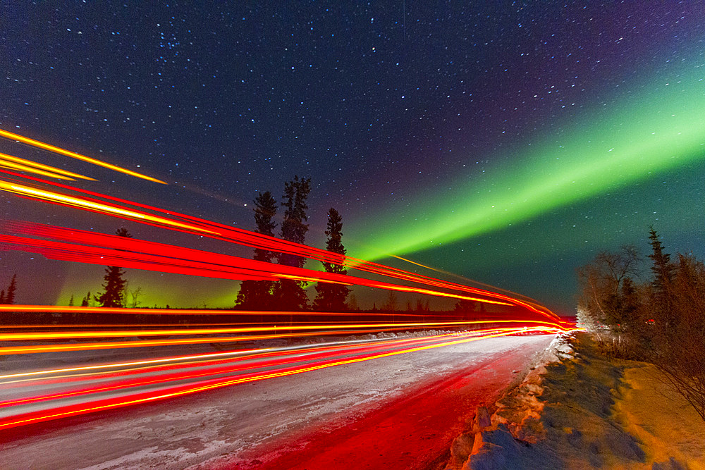Long exposure of Jeep lights and Aurora Borealis, on the Great Slave Lake, Northwest Territories, Canada.