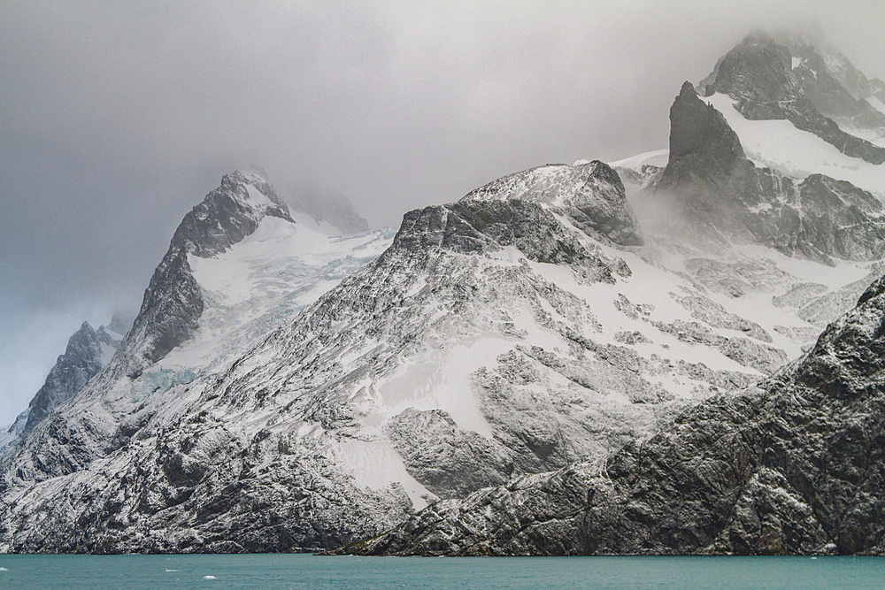 Views of Larsen Harbour in Drygalski Fjord during a snowstorm on South Georgia Island, Southern Ocean.